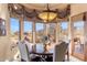 Cozy dining area with a bay window, stylish chandelier, and elegant furnishings at 15956 E Tombstone Trl, Fountain Hills, AZ 85268