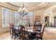 Formal dining room featuring a wooden table, elegant chairs, and natural light at 15956 E Tombstone Trl, Fountain Hills, AZ 85268