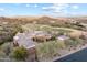 Grand estate features a tile roof, circular design, and lush desert landscaping in a picturesque golf course community at 15956 E Tombstone Trl, Fountain Hills, AZ 85268