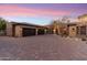 Beautiful home with a brick driveway, multi-car garage, desert landscaping, and a barrel roof at 15956 E Tombstone Trl, Fountain Hills, AZ 85268