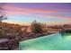 Scenic infinity pool blending seamlessly with the desert landscape, offering a tranquil escape and captivating views at 15956 E Tombstone Trl, Fountain Hills, AZ 85268