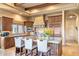Elegant kitchen featuring custom cabinets, granite countertops, an island with seating, and modern appliances at 15956 E Tombstone Trl, Fountain Hills, AZ 85268