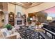 Elegant living room with fireplace, grand piano, and large windows showcasing outdoor views at 15956 E Tombstone Trl, Fountain Hills, AZ 85268