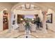 Bright living room showcasing a fireplace, grand piano, columns, and large picturesque window at 15956 E Tombstone Trl, Fountain Hills, AZ 85268