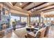 Comfortable living room with fireplace and a view of outdoor patio through the large windows at 15956 E Tombstone Trl, Fountain Hills, AZ 85268