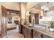Open main bathroom with dual sinks, granite counters, and views to the main bedroom at 15956 E Tombstone Trl, Fountain Hills, AZ 85268