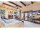 Spacious main bedroom with a fireplace, french doors, and ceiling beams at 15956 E Tombstone Trl, Fountain Hills, AZ 85268
