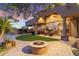 Enjoy outdoor gatherings on the spacious patio featuring a cozy fire pit, comfortable seating, and scenic desert views at 15956 E Tombstone Trl, Fountain Hills, AZ 85268