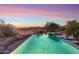 Inviting pool and spa offer a serene escape with sunset views of the golf course and surrounding desert landscape at 15956 E Tombstone Trl, Fountain Hills, AZ 85268