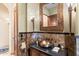 Elegant powder room with marble accents and a unique copper sink at 15956 E Tombstone Trl, Fountain Hills, AZ 85268