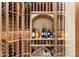 Custom wine cellar with wooden racks, glass doors, and ample storage for wine bottles at 15956 E Tombstone Trl, Fountain Hills, AZ 85268
