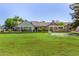 Beautiful backyard with a covered patio, lush lawn, mature trees, and a charming pool area for relaxation at 1632 S Alba Cir, Mesa, AZ 85204