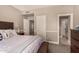 Cozy bedroom showing closet and bathroom door with a bed and end table at 1632 S Alba Cir, Mesa, AZ 85204