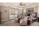 Bright bedroom with a ceiling fan, access to the pool, and comfortable seating area at 1632 S Alba Cir, Mesa, AZ 85204