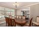 Formal dining room with elegant wood table and seating, views of the pool outside at 1632 S Alba Cir, Mesa, AZ 85204