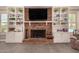 Living room fireplace featuring detailed brickwork and built-in shelving with decorative items at 1632 S Alba Cir, Mesa, AZ 85204