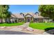 Exterior view of the home featuring beautiful landscaping, a manicured lawn, and a charming front entry at 1632 S Alba Cir, Mesa, AZ 85204