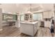 Open kitchen with large island, stainless steel appliances, and adjacent dining area with bright windows at 1632 S Alba Cir, Mesa, AZ 85204