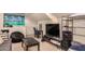 Spacious living room with TV, sofa, chairs, and storage, offering a comfortable and functional living space at 1632 S Alba Cir, Mesa, AZ 85204