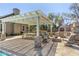 Outdoor kitchen with a built-in grill, picnic table, fire pit, seating, and pergola with ample space for entertaining at 1632 S Alba Cir, Mesa, AZ 85204