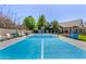 Bright blue and gray pickleball court featuring a basketball hoop with spectator seating under a clear, sunny sky at 1632 S Alba Cir, Mesa, AZ 85204