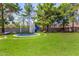 Backyard playground area featuring a swing set, slide, trampoline, and picnic table on a well-manicured lawn at 1632 S Alba Cir, Mesa, AZ 85204