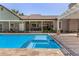 Inviting pool and spa area with a covered patio, outdoor seating, and a well-manicured lawn for relaxation at 1632 S Alba Cir, Mesa, AZ 85204