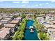 Aerial view of a community featuring a beautiful lake with a central pier and well maintained landscaping at 1679 E Dogwood Ln, Gilbert, AZ 85295