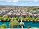 Beautiful aerial view of a suburban neighborhood with waterfront homes on a lake with mountain views at 1679 E Dogwood Ln, Gilbert, AZ 85295