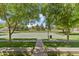 Community basketball court surrounded by lush greenery and mature trees on a sunny day at 1679 E Dogwood Ln, Gilbert, AZ 85295