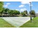 Outdoor basketball court with green surface and mature trees offering ample shade at 1679 E Dogwood Ln, Gilbert, AZ 85295