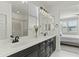 Bathroom featuring double sink vanity with black hardware, and separate shower at 1679 E Dogwood Ln, Gilbert, AZ 85295
