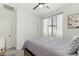 Bedroom with a ceiling fan, large window and closet at 1679 E Dogwood Ln, Gilbert, AZ 85295