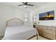 Comfortable bedroom with neutral tones, ceiling fan, and television over dresser at 1679 E Dogwood Ln, Gilbert, AZ 85295