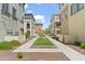 Beautiful community with a central green space, walkways, and various housing options at 1679 E Dogwood Ln, Gilbert, AZ 85295