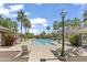 Resort-style community pool surrounded by lush landscaping and comfortable lounge seating at 1679 E Dogwood Ln, Gilbert, AZ 85295