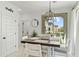 Bright dining area with stylish light fixture and view through sliding glass doors to the outside patio at 1679 E Dogwood Ln, Gilbert, AZ 85295