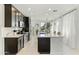 Modern kitchen featuring stainless steel appliances, dark cabinets, and a large island with breakfast bar at 1679 E Dogwood Ln, Gilbert, AZ 85295