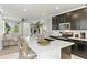 Modern kitchen featuring a large island, dark cabinetry, stainless steel appliances, and eat in area at 1679 E Dogwood Ln, Gilbert, AZ 85295