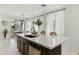 Modern kitchen island featuring stainless steel dishwasher, pendant lighting and a view to the outdoor dining at 1679 E Dogwood Ln, Gilbert, AZ 85295