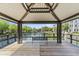 Picturesque lakeside gazebo with seating, providing a tranquil and scenic spot for relaxation at 1679 E Dogwood Ln, Gilbert, AZ 85295