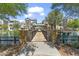 Stunning lake view featuring a wooden bridge, gazebo, and waterfront residences on a sunny day at 1679 E Dogwood Ln, Gilbert, AZ 85295