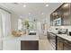 Bright and airy living room with modern furnishings and a view into the kitchen at 1679 E Dogwood Ln, Gilbert, AZ 85295