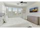 Bright main bedroom with natural light, ceiling fan, and television over dresser at 1679 E Dogwood Ln, Gilbert, AZ 85295