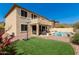 Spacious backyard with artificial turf, pool, outdoor seating, and basketball hoop at 17005 S Coleman St, Phoenix, AZ 85045