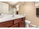 Bathroom with wood cabinets, a large mirror, and a shower with a glass door at 17005 S Coleman St, Phoenix, AZ 85045