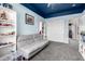 Carpeted bedroom featuring shelving, a sofa, and a decorative blue ceiling at 17005 S Coleman St, Phoenix, AZ 85045