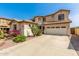 Exterior of a stucco home with a large driveway and desert landscaping at 17005 S Coleman St, Phoenix, AZ 85045