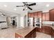Spacious kitchen features a center island, stainless steel appliances, and open concept floorplan at 17005 S Coleman St, Phoenix, AZ 85045