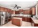 Spacious kitchen features stainless steel appliances, wooden cabinets, and center island at 17005 S Coleman St, Phoenix, AZ 85045
